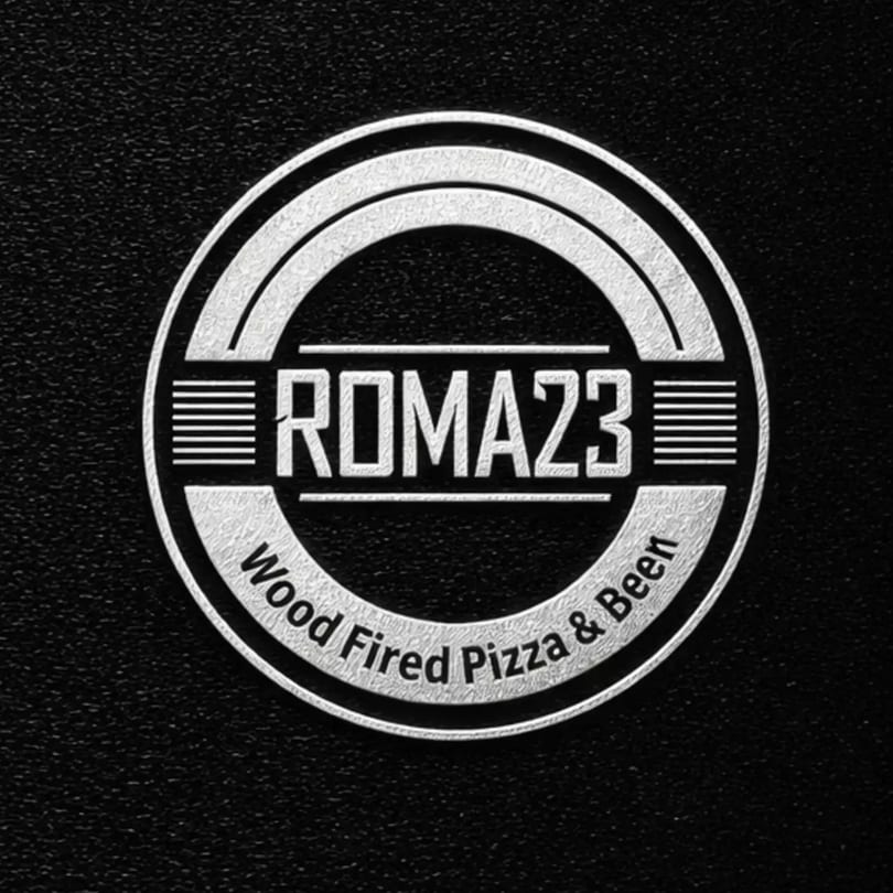 Silver Roma23 Wood Fired Pizza & Beer logo on a textured black background.